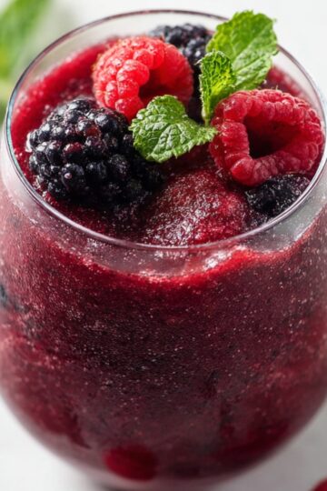 5-Minute Red Wine Slushies Recipe | Frozen Sangria 26 red wine slushies Glass of frozen red wine berry slushie topped with raspberries, blackberries, and fresh mint leaves