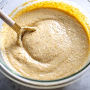 Cornbread Recipe: Easy 40-Minute Homemade Version 15 "A close-up view of cornbread batter spread evenly in a pan before baking. The batter is thick and ready for the oven."