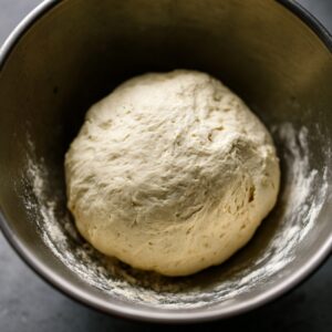 Healthy Naan Bread Recipe 14 Smooth, risen naan dough resting in a mixing bowl after the first rise.