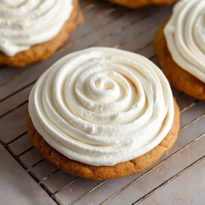 Healthy Tiramisu Cookies Recipe In 30 Minutes 18 A close-up of a soft, freshly baked tiramisu cookie with a generous swirl of whipped cream on top, ready to be enjoyed as a perfect dessert treat.