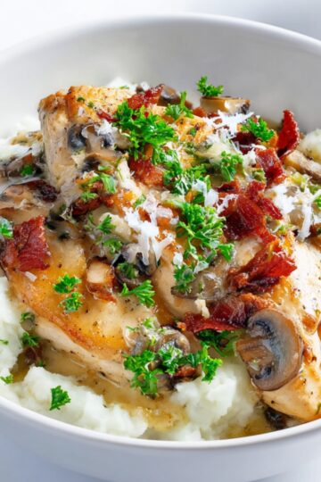 Creamy Mushroom Chicken Creamy chicken with mushrooms and bacon in garlic cream sauce over mashed potatoes