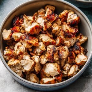 Healthy Greek Bowl Recipe with Chicken & Tzatziki (35 Min) 15 Bowl of grilled Greek-style chicken cut into bite-sized pieces with golden edges and juicy texture